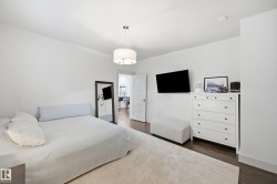 Recessed lighting and ceiling-mounted drum light fixture illuminate wood-finish flooring - 