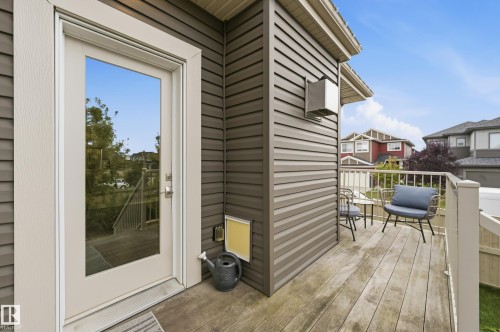 Exterior deck with wood-finish flooring, white railing, and brown siding - 1961 Adamson Terrace Sw, Edmonton, AB 