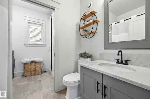 White vanity with a light gray cabinet, white countertop, and matte black faucet - 1961 Adamson Terrace Sw, Edmonton, AB 