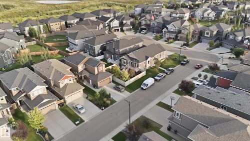 Aerial perspective showcasing a residential neighborhood with varied architectural styles and a visible body of water in the background - 1961 Adamson Terrace Sw, Edmonton, AB 