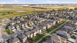 Residential development featuring a variety of architectural styles, paved streets, and green spaces - 