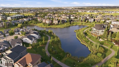 Expansive residential area with a prominent central lake, winding pathways, and green spaces - 1961 Adamson Terrace Sw, Edmonton, AB 