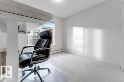 Light-toned wall finishes, carpeted flooring, and a large window providing ample natural light - 