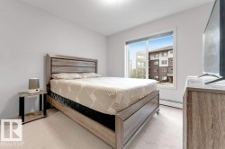 Neutral wall paint, light-toned carpeting, and a large window providing natural light - 