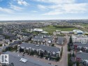 Aerial perspective showcasing a residential neighborhood with varied housing types including detached homes and multi-story apartment buildings - #224 390 Windermere Rd Nw, Edmonton, AB 