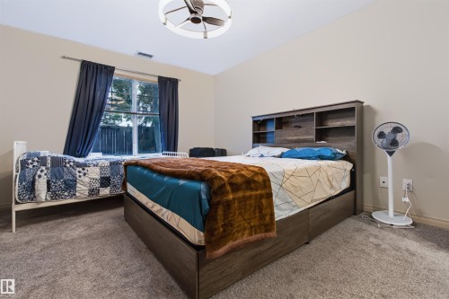 Carpeted flooring with neutral wall tones and a window with curtains - #155 2096 Blackmud Creek Dr Sw, Edmonton, AB 