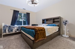 Carpeted flooring with neutral wall tones and a window with curtains - 