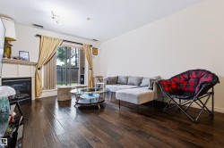 Rich wood-finish flooring, a built-in fireplace with a mantel, and a sliding glass door with exterior access - 