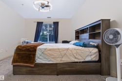 Carpeted flooring, window with dark drapes, and a ceiling fan with integrated lighting - 