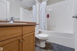 Wood-finish vanity with an integrated sink and chrome faucet - 