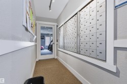 Mailroom with individual mailboxes and track lighting - 