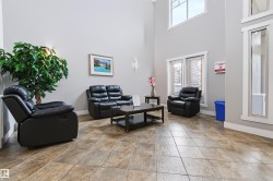 High ceilings and light gray walls complement the rectangular floor tiles - 