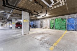 Concrete flooring throughout, exposed concrete ceiling, and exposed utility piping - 