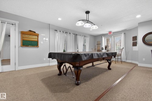 Carpeted room with recessed lighting and a multi-light pendant fixture - #155 2096 Blackmud Creek Dr Sw, Edmonton, AB 