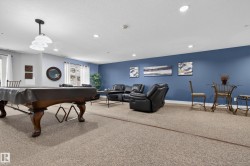 Recessed ceiling lighting, carpeted flooring, pendant lighting fixture, multiple windows, built-in pool table - 