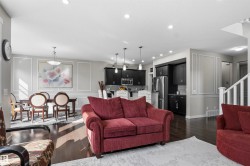 Open-concept living area with dark wood-finish flooring, recessed lighting, and decorative wall molding - 