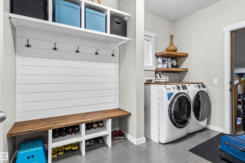 Built-in shiplap mudroom bench with cubby storage and coat hooks - 8515 19 Avenue Sw, Edmonton, AB 