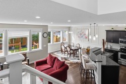 Open-concept living space with dark wood-finish flooring - 