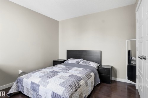 Hardwood-finish flooring, light neutral wall paint, and a classic white paneled door - 8515 19 Avenue Sw, Edmonton, AB 
