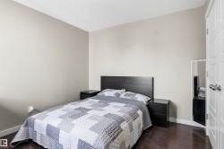 Hardwood-finish flooring, light neutral wall paint, and a classic white paneled door - 