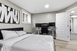 Recessed lighting, light-toned walls, wood-finish flooring, white paneled door, and a window with white blinds - 