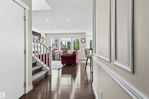 Hardwood-finish flooring, recessed lighting, wainscoting, and white trim accents - 8515 19 Avenue Sw, Edmonton, AB 