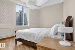 Hardwood flooring, large window, patterned wall accents, exposed ductwork, and crown molding - 