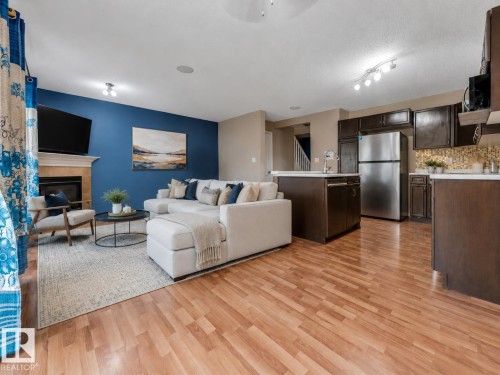 AI-ENHANCED IMAGE — FOR ILLUSTRATION PURPOSES ONLY - 7743 8 Avenue Sw, Edmonton, AB - Indoor With Fireplace
