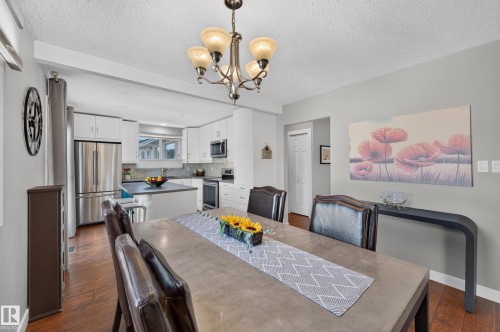 Dining area with a multi-light chandelier, recessed lighting, and wood-finish flooring - 7704 13 Avenue Nw, Edmonton, AB 