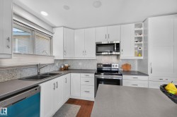 White cabinetry and stainless steel appliances - 