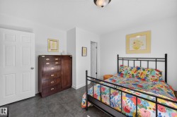 White painted walls, dark flooring, and a six-panel interior door - 