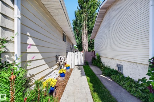 Exterior siding, white picket gate, paved walkway - 7704 13 Avenue Nw, Edmonton, AB 