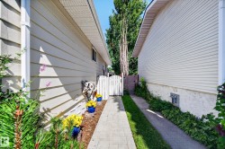 Exterior siding, white picket gate, paved walkway - 