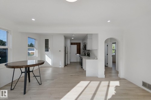 Recessed lighting illuminating wood-finish flooring - 11914 124 Street Nw, Edmonton, AB 
