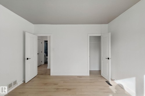 Wood-finish flooring with white walls and trim - 11914 124 Street Nw, Edmonton, AB 