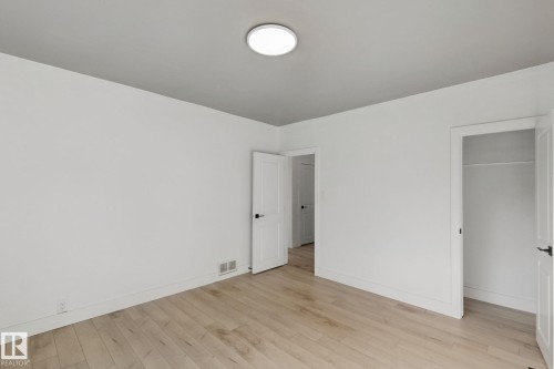 Light wood-finish flooring with white walls - 11914 124 Street Nw, Edmonton, AB 