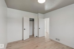 Light wood-finish flooring with white baseboards - 