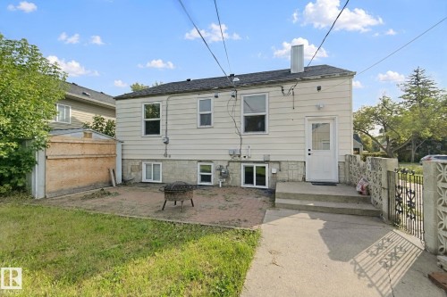 Rear exterior with durable siding, concrete steps, and a paved patio area - 11914 124 Street Nw, Edmonton, AB 