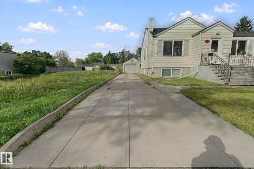 Expansive paved driveway leading to a detached garage - 11914 124 Street Nw, Edmonton, AB 