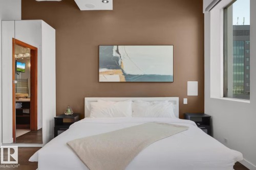 Recessed ceiling lighting, wood-finish flooring, built-in ceiling speakers, and large window - #701 10105 109 St Nw, Edmonton, AB 
