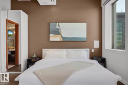 Recessed ceiling lighting, wood-finish flooring, built-in ceiling speakers, and large window - 