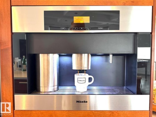 Built-in Miele coffee system with stainless steel accents and a digital display - #701 10105 109 St Nw, Edmonton, AB 