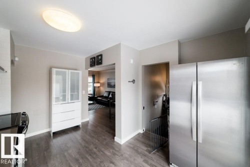 Stainless steel side-by-side refrigerator, wood-finish flooring, and recessed ceiling lighting - 12228 134 Street Nw, Edmonton, AB 
