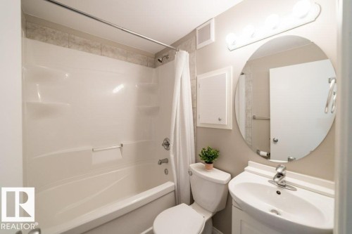 Alcove bathtub with integrated shelving and tiled surround - 12228 134 Street Nw, Edmonton, AB 