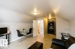 Sloped ceilings, neutral wall tones, and square tile flooring - 