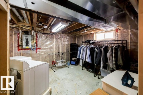 Unfinished basement with exposed ceiling joists, visible electrical panel, and a single window - 12228 134 Street Nw, Edmonton, AB 