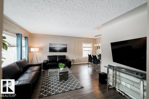 Wood-finish flooring throughout the main living area - 12228 134 Street Nw, Edmonton, AB 