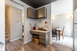Built-in desk area featuring grey cabinetry and a light-colored countertop - 