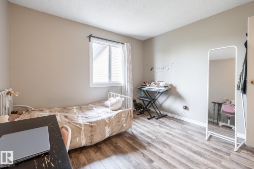 Neutral wall tones complementing wood-finish flooring - #20 3812 20 Av Nw, Edmonton, AB 
