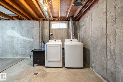 Utility area featuring concrete walls, exposed ceiling joists, and a small casement window - #20 3812 20 Av Nw, Edmonton, AB 
